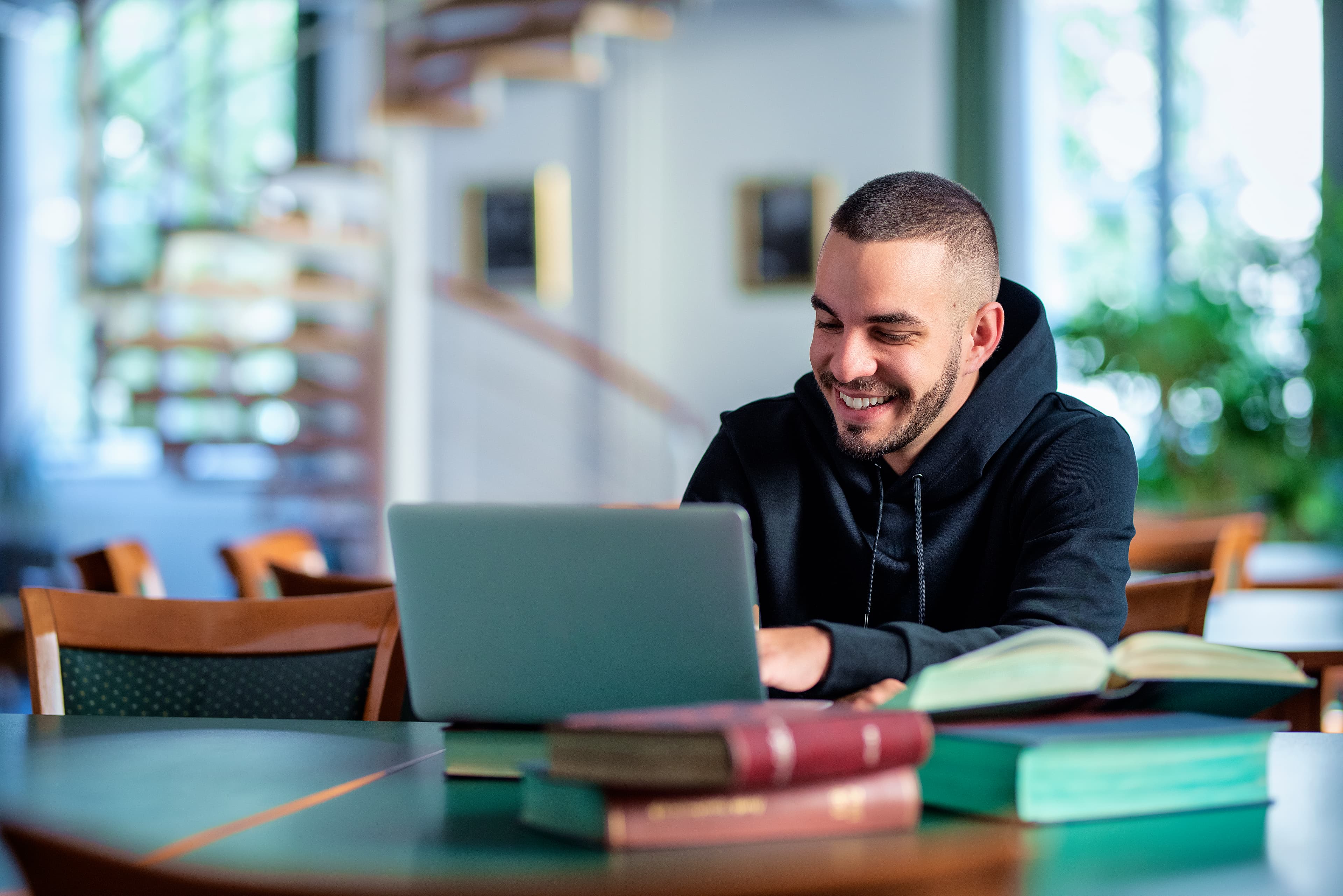 Law student working through a legal concept on a laptop in a study room