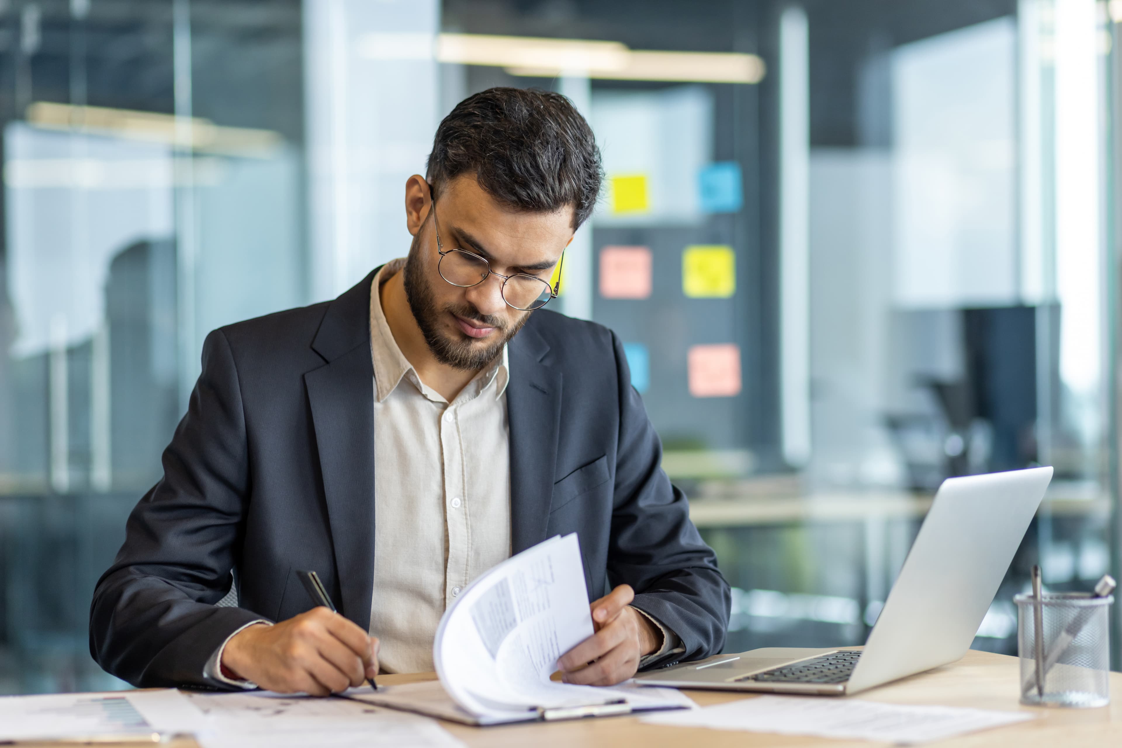 Student drafting a written exam answer in an office